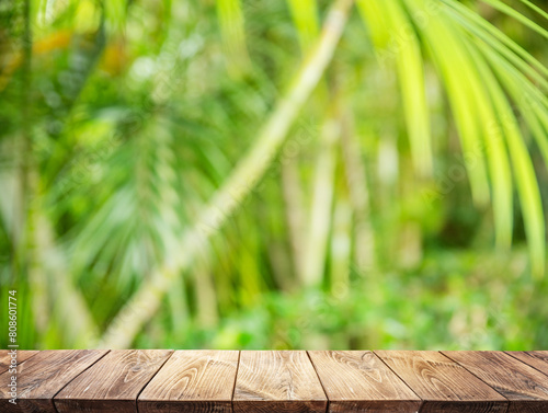 Empty wooden board or table top and blurred green bamboo culms. Place for your product display.