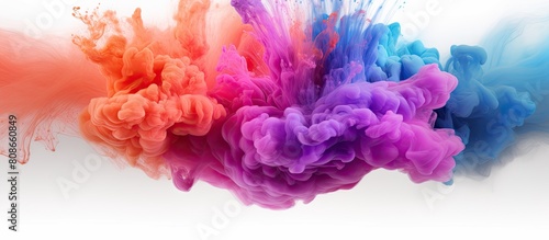 Multicolored powder cloud with an abstract design against a white background provides ample copy space for images