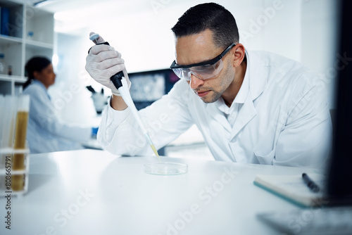Scientist, man and pipette on petri dish for research, test or chemical analysis for healthcare innovation in laboratory. Dropper, science and medical study of drugs, liquid or exam for biotechnology