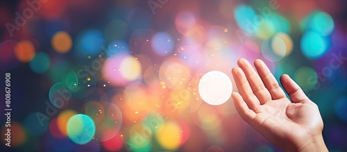 A male hand with an open palm is seen in the bottom left corner of the Rainbow Bubble Message Banner Template The background consists of a wide multicolored bubble bokeh providing space for text
