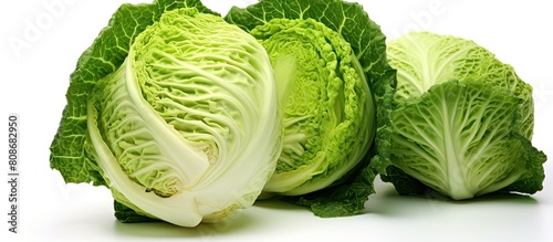 A green cabbage is seen in this isolated copy space image set against a clean white background with a clipping path