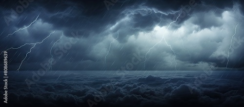 Dark stormy rainclouds fill the sky creating a dramatic atmosphere. Copy space image. Place for adding text and design