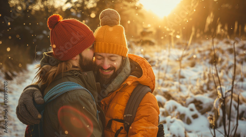 sweet queer couple cuddle in sunshine on winter hike in europe Stock Photo photography