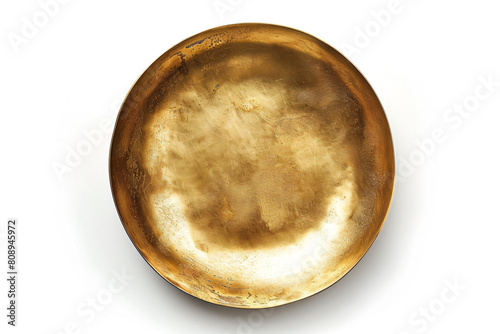 a gold plate on a white surface