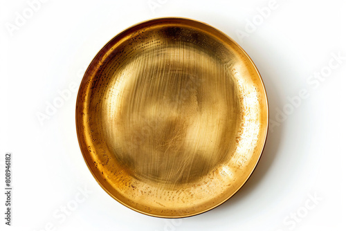 a gold plate on a white surface