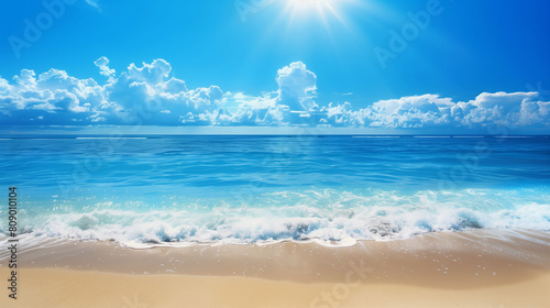 A beautiful beach with a clear blue ocean and a few small islands in the distance. The sky is mostly clear with a few clouds scattered throughout. The scene is peaceful and serene, with the calm ocean
