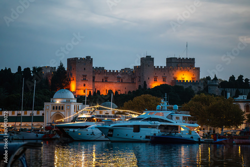 Expensive yachts against the backdrop of the Rhodes Fortress on the island of Rhodes.