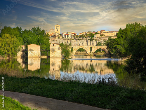 Zamora old town seen form Douro river, Acenas and stone bridge in the foreground, Cathedral in background, Spain