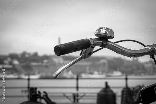 Close-up of a bicycle handlebar in black and white