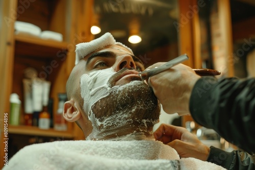 A man is shaving his face using a razor, A barber using hot towels and straight razors for a luxurious shave experience