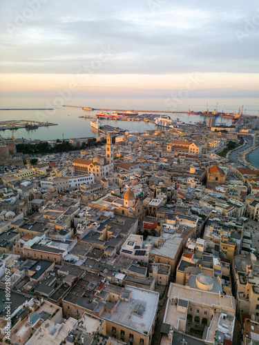 Aerial view of Bari city center with churches in Puglia during sunset and marina in the background, Italy