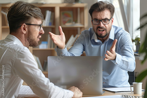 Angry boss criticizing scolding sad male employee for computer mistake incompetence at workplace, mad leader reprimanding rebuking shouting at subordinate lazy worker blaming of bad work in office 