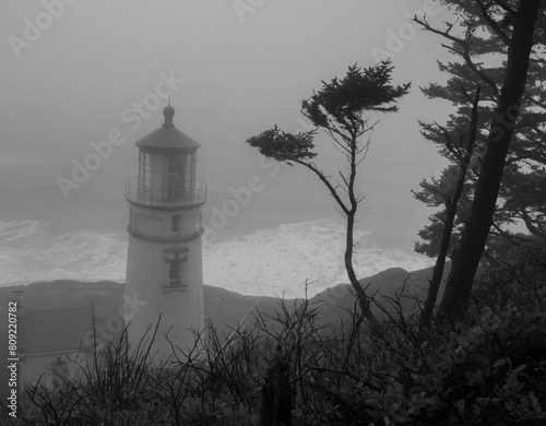 Foggy lighthouse beach scene, Oregon coast