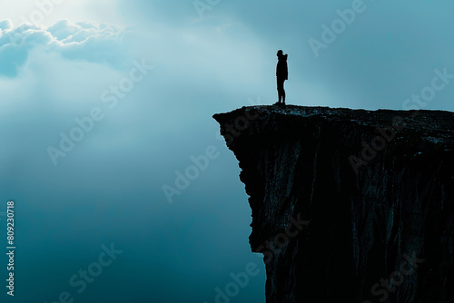 Silhouette of a Person on Cliff Edge Symbolizing Fear of Heights and Danger