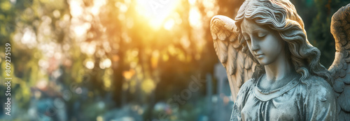 Panorama angel statue on a cemetery in sunlight
