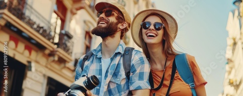 A two young female and male tourists with camera in the hand and enjoying their holidays.