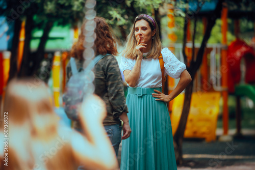  Mothers Talking at the Playground While Kids Play in SwingsMom friends gossiping together in the park while children play 