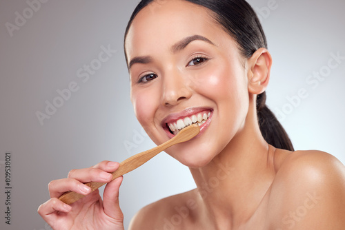 Portrait, smile and toothbrush with oral hygiene woman in studio on gray background for dental care. Face, mouth and happy person brushing teeth in bathroom to prevent cavity, decay or gum disease