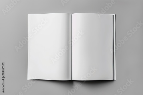 A plastic rectangle with transparent paper, empty pages, sits on a gray surface