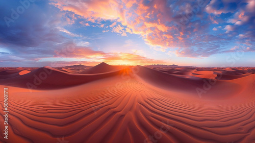 Sunrise over red sand dunes in desert landscape
