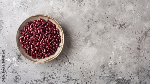 Raw red beans displayed in a ceramic dish on a pale gray kitchen countertop Genuine Vegetarian Product