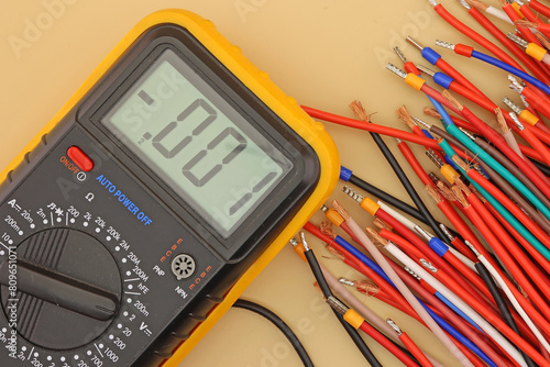 A digital multimeter for measuring the parameters of electrical circuits in an electrical diagram. Close-up.