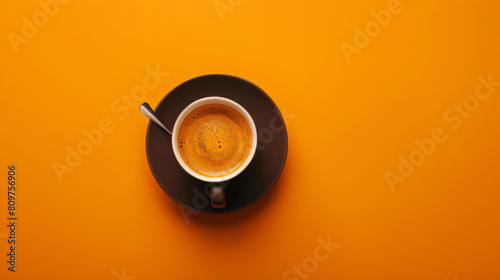 Cup of hot espresso on orange background