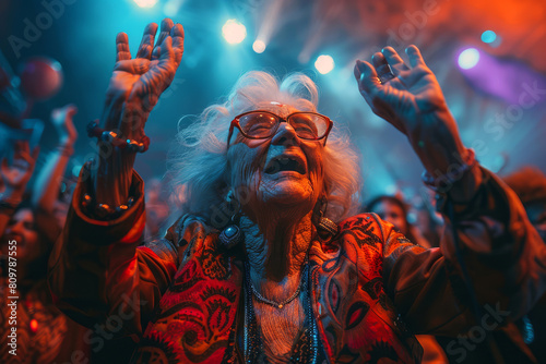 An elderly woman raises her arms in sheer joy, swaying to the beats at a vibrant concert under dazzling lights