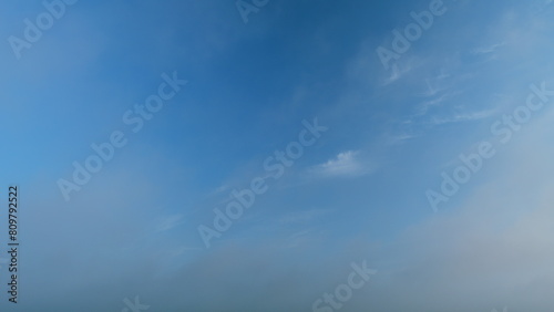 Blue heaven summer cloudscape. Rolling puffy white layered clouds are moving. Timelapse.