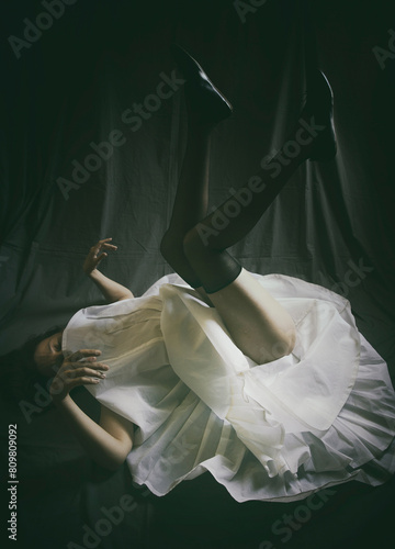 dancer lying on the floor with her legs up in a desolate attitude
