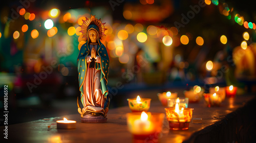 Statue of the virgin mary surrounded by lit candles