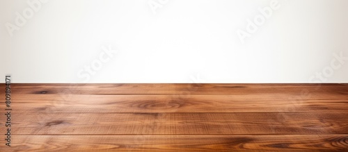 A brown wooden tabletop is situated on a white background with plenty of space for images. Creative banner. Copyspace image