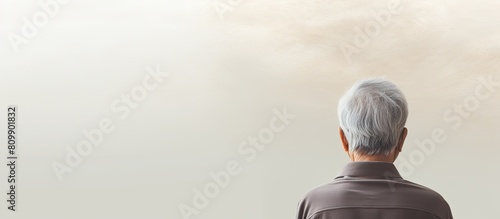 The rear view of the elderly person in the copy space image