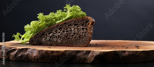 An isolated copy space image of pumpernickel bread covered in mold conveniently placed on a wooden cutting board