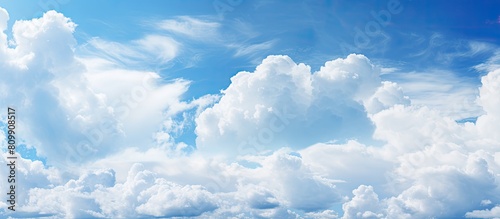A background image featuring a copy space image of a blue cloudy sky with textured white clouds
