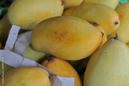 A mango is an edible stone fruit produced by the tropical tree Mangifera indica. It originated from the region between northwestern Myanmar Bangladesh and northeastern India