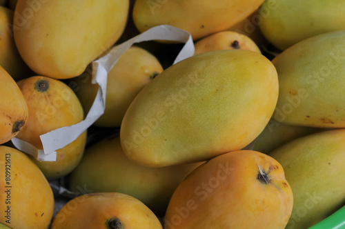 A mango is an edible stone fruit produced by the tropical tree Mangifera indica. It originated from the region between northwestern Myanmar Bangladesh and northeastern India