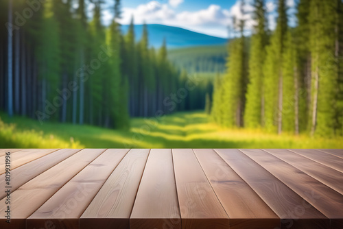 The empty wooden table top with blur background of boreal forest. Exuberant image 