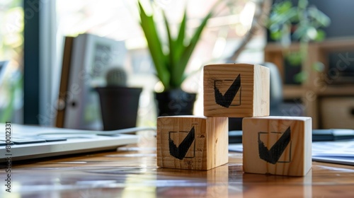 Wooden blocks with check marks building up on an office desk during a busy workday