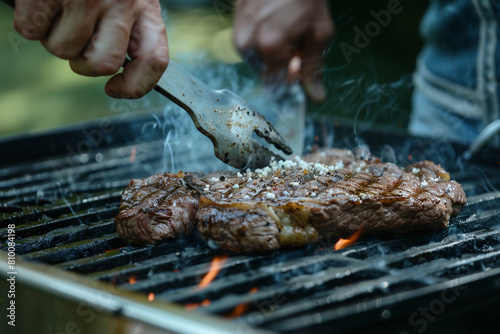 A home cook sweats as they try to flip a steak on the grill. They are worried about making a mistake and ruining the meal for their guests