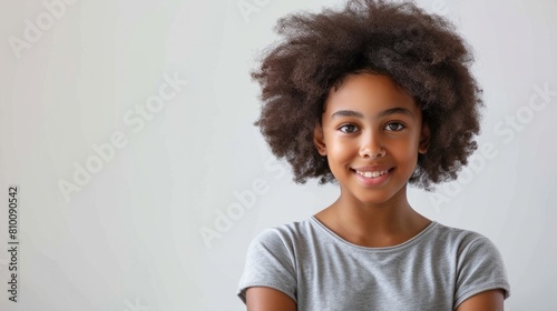 portrait beautiful afro american teenager girl dressed in t-shirt and smiling, light background hyper realistic 