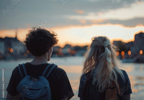 A young woman and her boyfriend enjoying the sunset view.