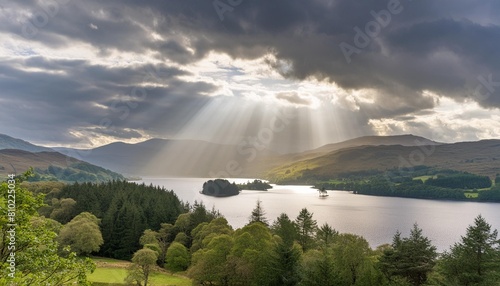 photograph showing dramatic light rays through the clouds over loch tay in scotland