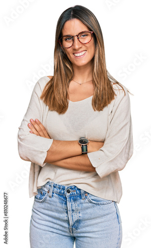 Young woman wearing casual clothes and glasses happy face smiling with crossed arms looking at the camera. positive person.