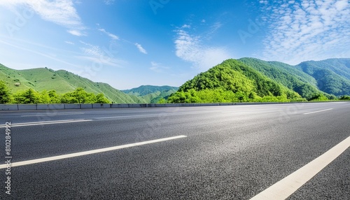 asphalt road and green mountain nature landscape under blue sky