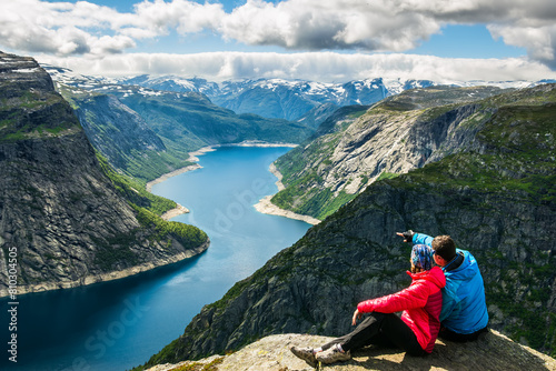 Adventurous couple enjoying majestic fjord view