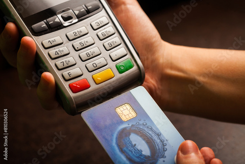 Person completing a card payment on a pos terminal