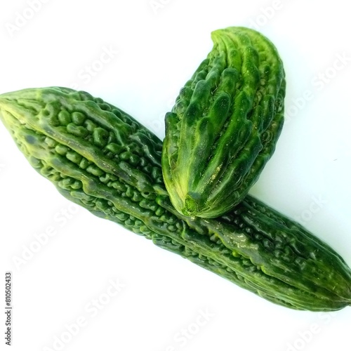 Bitter melon with white background. Bitter melon used as vegetables and other benefits. Bitter Melon has a bumpy skin and ranges from light to dark yellowish green in color. 