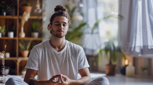 A young Caucasian man meditating in a lotus position at home, surrounded by a serene and orderly environment