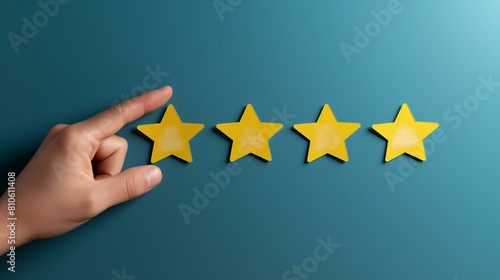 Hand Pointing to a Yellow Star on a Teal Background, Rating Concept